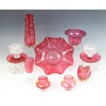 A pair of Victorian cranberry and clear glass table lustres, each upon a petal cut base,