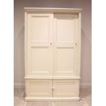 A Victorian painted pine housekeepers cupboard, the moulded cornice above a pair of sliding panelled