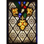 A stained glass window panel, 19th century and later, the glass pieces predominantly painted with