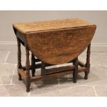 An 18th century oak gateleg table, the oval drop leaf top raised upon baluster and bobbin turned