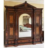 A large and impressive late 19th century French figured walnut compactum wardrobe, of