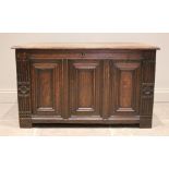An early 18th century oak coffer, the rectangular moulded top over three front panels, enclosed by
