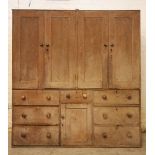 A 19th century scumbled pine housekeepers cupboard, with four panelled cupboard doors above the base