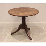 A George III mahogany tripod table, the circular top raised upon a baluster pedestal extending to