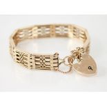A gold coloured bracelet, each panel with pierced decoration, interspersed by articulated links,