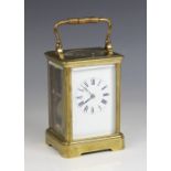 An early 20th century brass cased repeater carriage clock, the 6cm white enamelled dial applied with