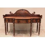 A George III mahogany sideboard, the break arch raised back with a rope twist 'moustache' top