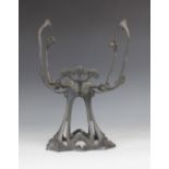 An Austrian Successionist cast spelter centrepiece, in the manner of Loetz, designed as four sinuous