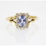 An iolite and diamond 18ct gold ring, the central rectangular step cut iolite measuring 6mm x 4mm,