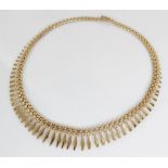 A continental 9ct gold fringe collarette, the graduated lozenge shaped links with floral detail,