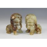 A pair of Chinese carved jade coloured dogs of fo, each modelled seated on hind legs, 9.5cm high