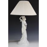 A continental porcelain figural table lamp, 20th century, modelled as a Pre-Raphaelite maiden