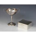 A silver coloured twin-handled trophy cup, the circular bowl with loop handles on tapered stem and