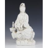 A Chinese Porcelain Blanc de Chine/Dehua model of Guanyin, modelled seated upon a rocky outcrop