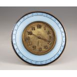 An enamelled 8 day desk clock, the circular dial with Arabic numerals and outer seconds track, the