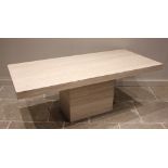 A contemporary limestone table, late 20th/early 21st century, the rectangular top raised upon a