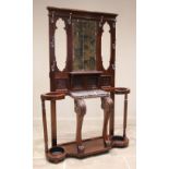 A late Victorian walnut mirror back hall stand, the rectangular mirrored back above a marble shelf