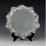 An Edwardian silver salver, Barker Brothers, Birmingham 1903, of circular form with shell and scroll