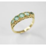 A Victorian style five stone ring, comprising five graduated round mixed cut blue-green gemstones (