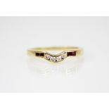 An 18ct gold ruby and diamond ring, the arched head channel set with four brilliant cut diamonds,