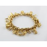 A gold coloured charm bracelet, the belcher link chain with spring ring and loop fastening,