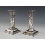 A pair of early 20th century silver mounted candlesticks by Henry Matthews (date and assay marks