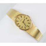 A lady's Tissot Stylist 18ct gold wristwatch, the brushed gold coloured oval dial with baton