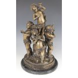 A bronzed Bacchanalian group of five putti, the central figure holding a wine goblet and standing