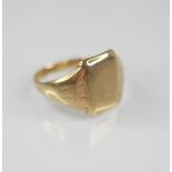 A gentleman's gold coloured signet ring, the plain polished rectangular cartouche measuring 14mm x