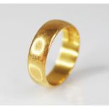 A 22ct gold wedding band, marks for 'HWLd', Birmingham 1918, ring size T 1/2, weight 7.4gms