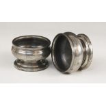 A pair of early 19th century pewter salts, each of compressed circular form on pedestal foot,