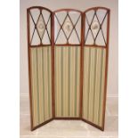 An Edwardian mahogany and satinwood cross banded three fold room screen, each arched panel with a