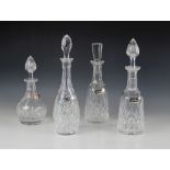 Four early 20th century cut glass decanters with associated stoppers, measuring between (excluding