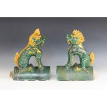 A pair of Chinese Sancai glazed roof tiles, each modelled as a Kylin (Qilin), 34cm high (at fault)