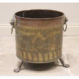 A brass and copper log bin, early 20th century, of cylindrical form, applied with lion mask ring