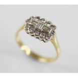 A diamond 18ct gold cluster ring, the central boat shaped cluster designed as three baguette cut