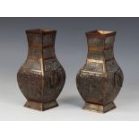 A pair of Chinese bronze vases, 19th/20th century, each of archaic square section baluster form with