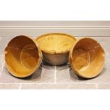 Three stoneware dairy or confit bowls, each with a glazed interior, the largest with integrated twin