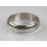 A platinum wedding band, marks for 'BMS', Birmingham 2000, ring size T 1/2, weight 10.4gms