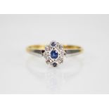 An early 20th century sapphire and diamond 18ct gold and platinum ring, designed as a central oval