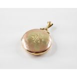 An Edwardian 9ct gold locket pendant, of circular form with monogrammed initials to cover, opening