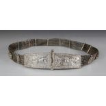 An Indian silver coloured belt, designed as two tapered rectangular buckles, ornately embossed