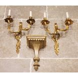 A pair of French ormolu rococo style twin branch wall light fittings, each cast with scrolling