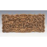 A Chinese carved sandal wood panel, 19th century, of shaped rectangular form and carved in relief