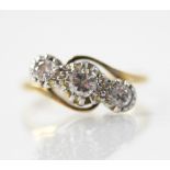 A diamond three stone ring, the central round mixed cut diamond weighing between 0.15-0.20 carats,