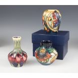 Three boxed Moorcroft vases of small proportions, comprising: a shouldered baluster decorated in the