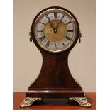 A large French mahogany cased balloon clock, 19th century and later, the case surmounted with gilt