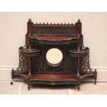 An early 20th century Chinese Chippendale revival mahogany wall shelf, of fretwork form, the central