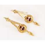 A pair of Victorian drop earrings, each designed as a triangular dropper with scalloped borders,