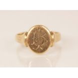 A 9ct gold signet ring, the central oval head measuring 13mm x 11mm, engraved with monogrammed